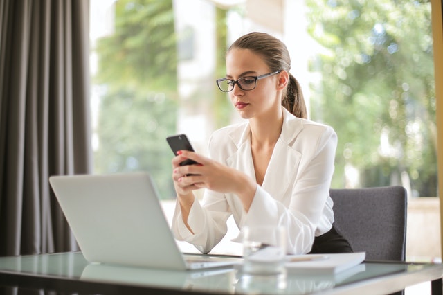Serious Businesswoman Using Smartphone In Workplace 3761520