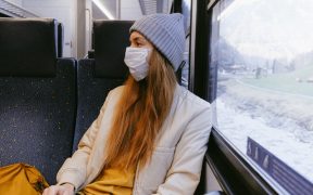 woman in gray knit cap and beige coat 3962212