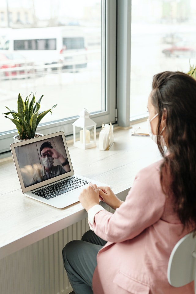 woman using her laptop on video call 4031821