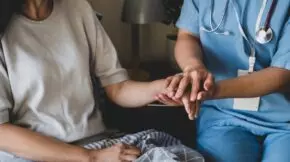 a nurse holding a patients hand description auto