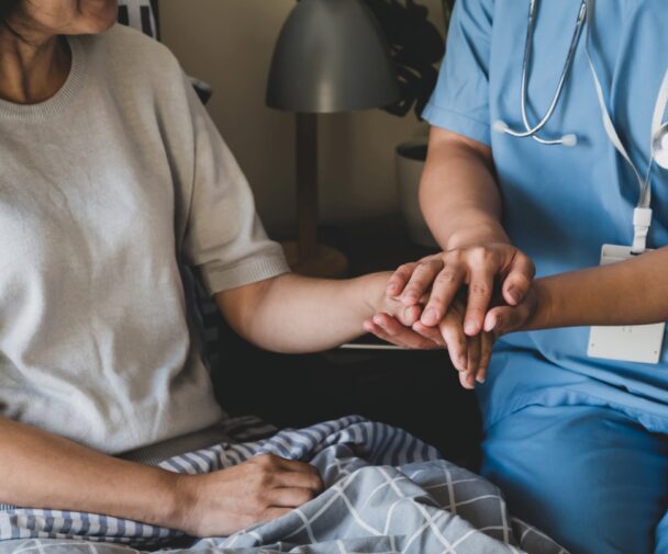 A Nurse Holding A Patients Hand Description Auto